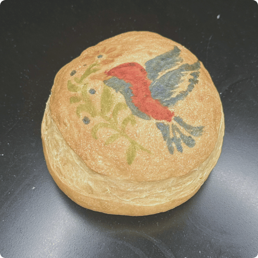 bird painted bread of a bird. The colors are faded.